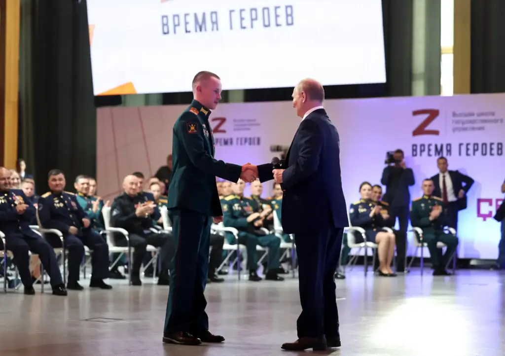 Russian President Vladimir Putin congratulates Stepan Belov.