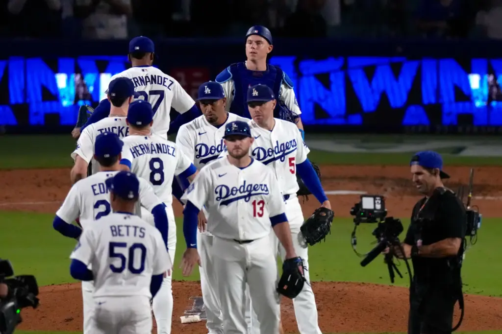 Members of the Dodgers celebrate after they defeated the San...