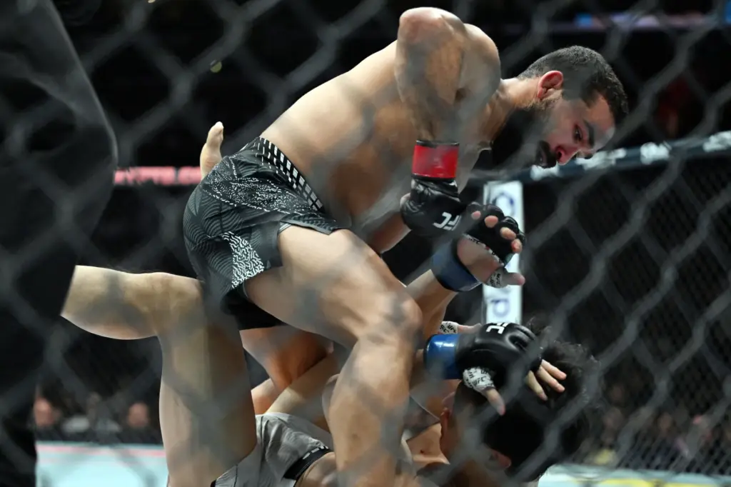 Patricio Pitbull drops punches onto Dooho Choi during their fight...