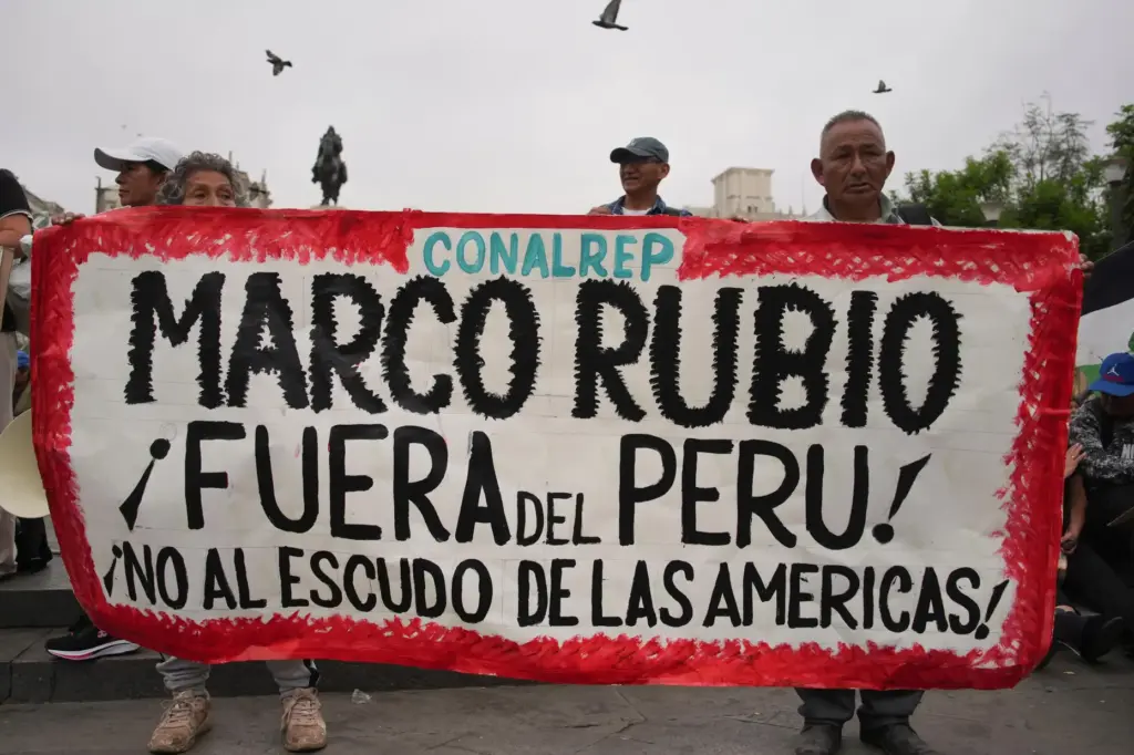 People protest the visit of U.S. Secretary of State Marco Rubio.