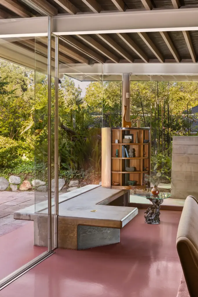 A built-in concrete bench in the living room pierces through...