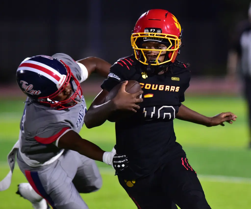 Hawthorne QB Daniel Green escapes Leuzinger defender in the Annual...
