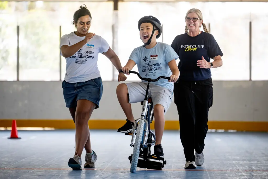 iCan Bike Camp volunteers Harini Srinivasam, left, and Amy Dibello,...