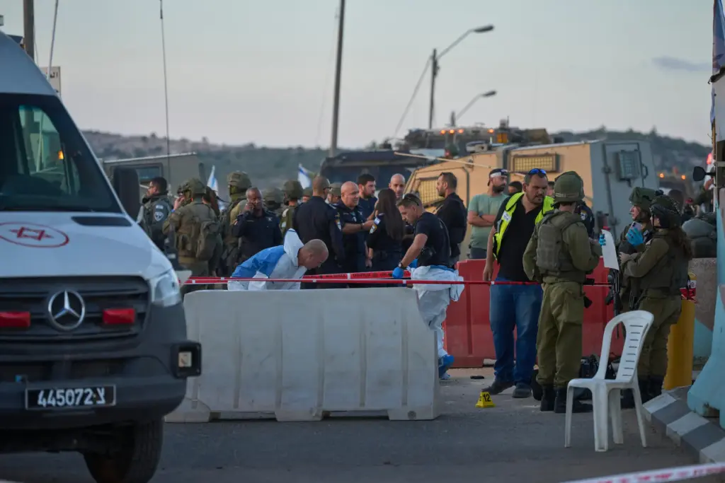 Israeli security forces inspect the scene where, according to police,...