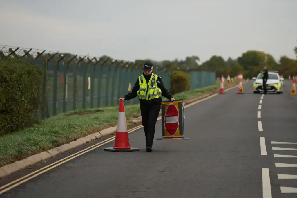 Police officers guard a road leading to RAF Fairford.