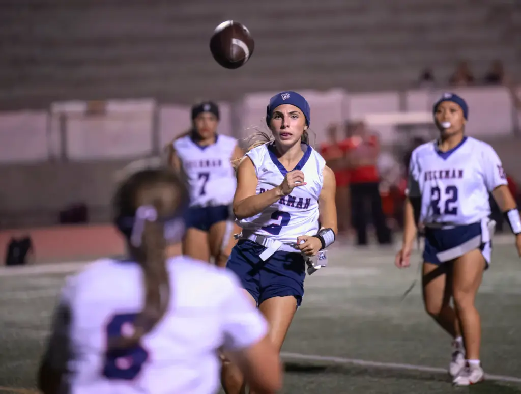 Beckman quarterback Marina Babayani, center, fires a pass to wide...