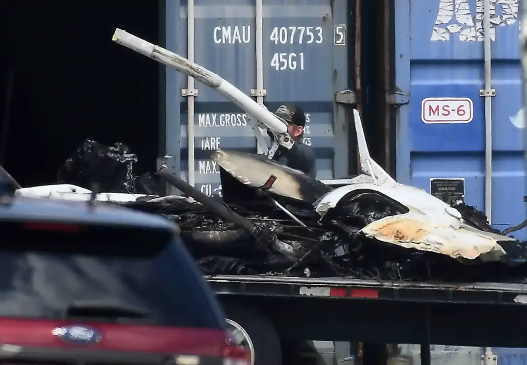 Salvage crews help NTSB investigators remove of whatâs left of...