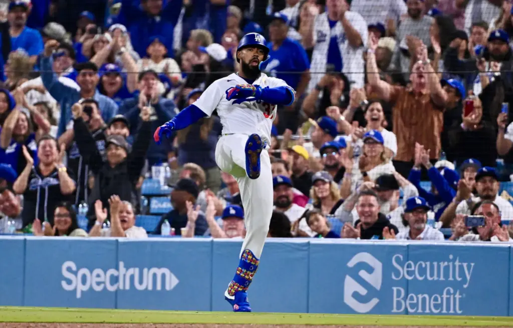 Dodgers outfielder Teoscar HernÃ¡ndez reacts after hitting an RBI single...