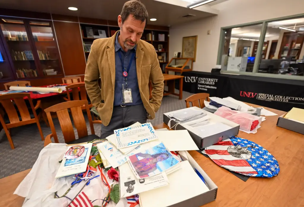 Professor David G. Schwartz looks over artifacts that were part...