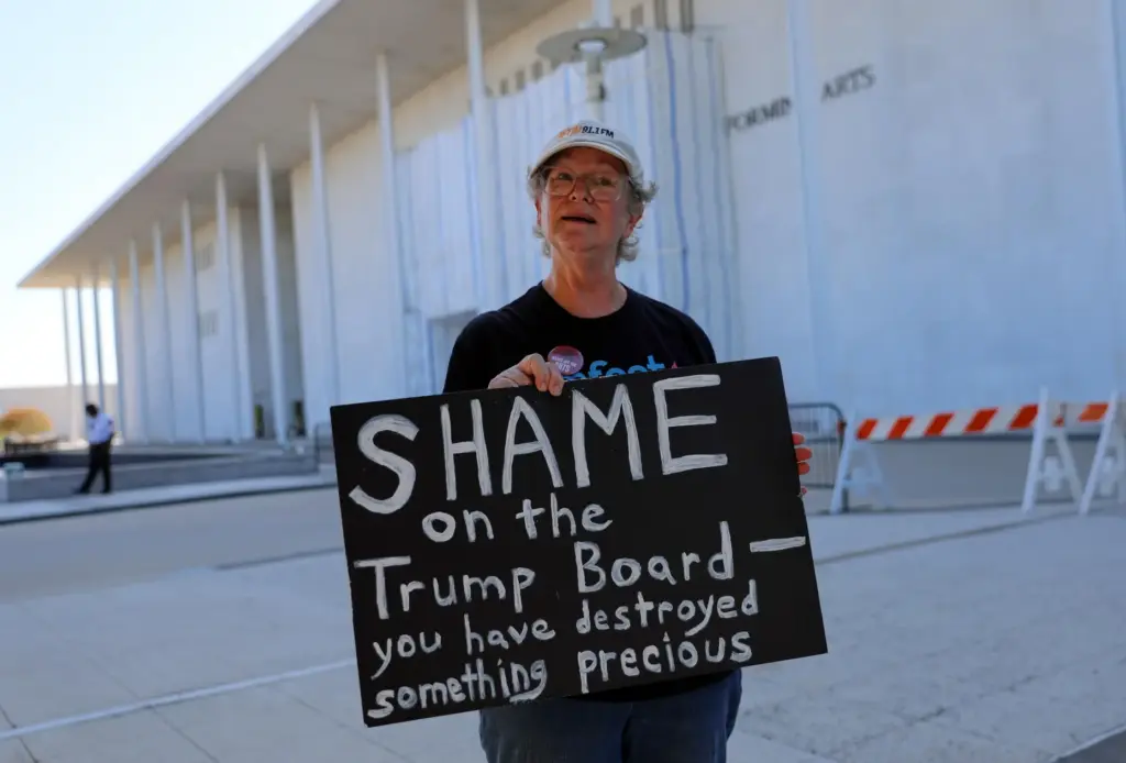 Laura Bligh of Vienna, Va., holds a protest sign outside...