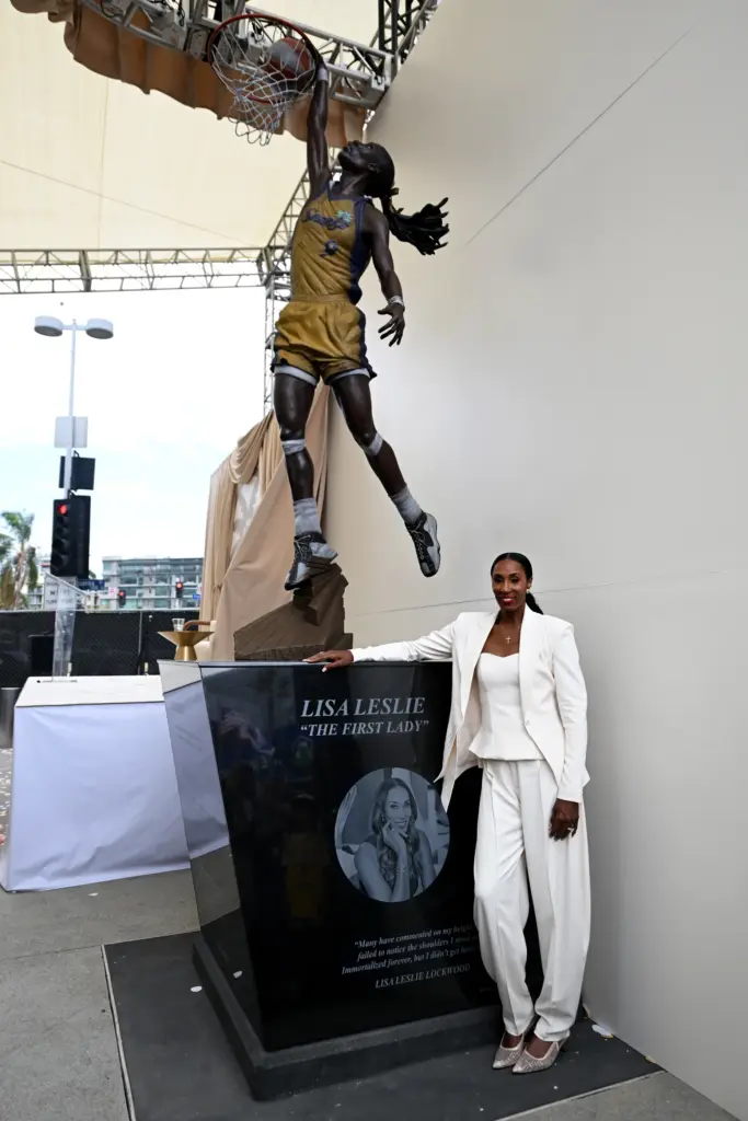 Hall of Fame basketball player Lisa Leslie poses next to...