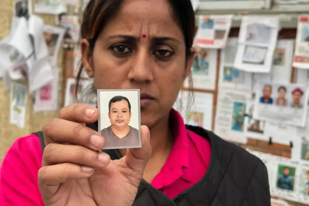 Usha Khatri shows a photo of her husband, Indra Bahadur.
