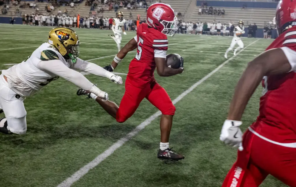 Orange Lutheranâs King Rich Johnson (5) returns an interception for...