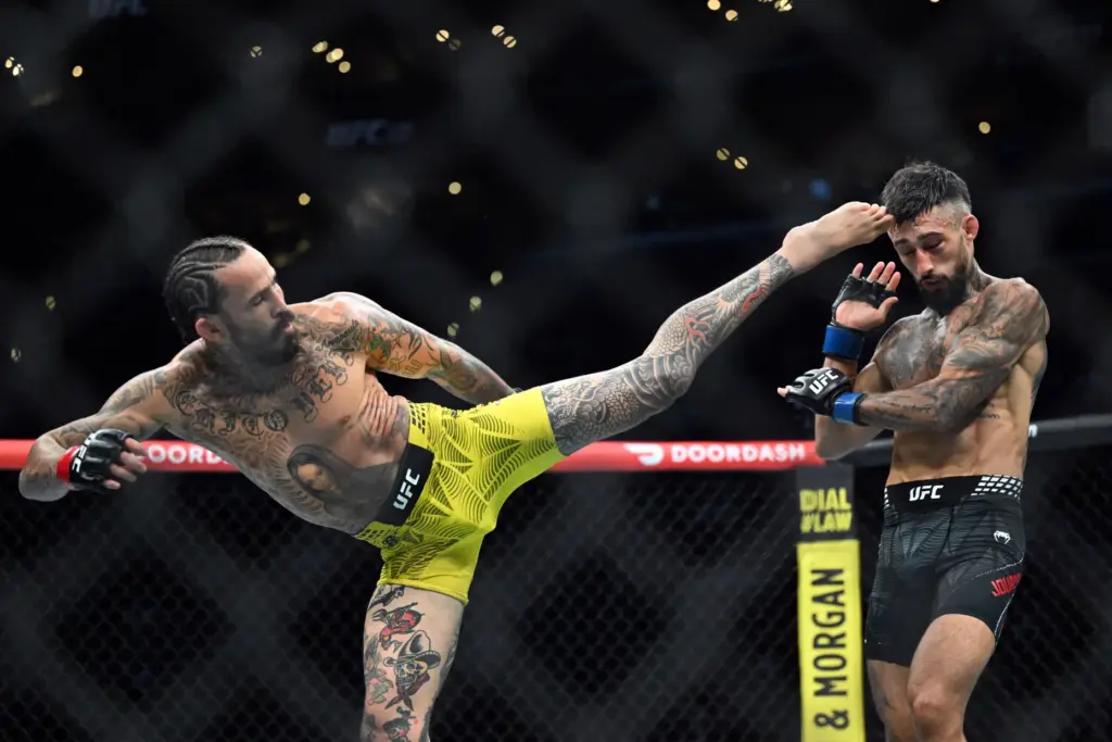 Marlon Vera throws a kick at Charles Jourdain during their...