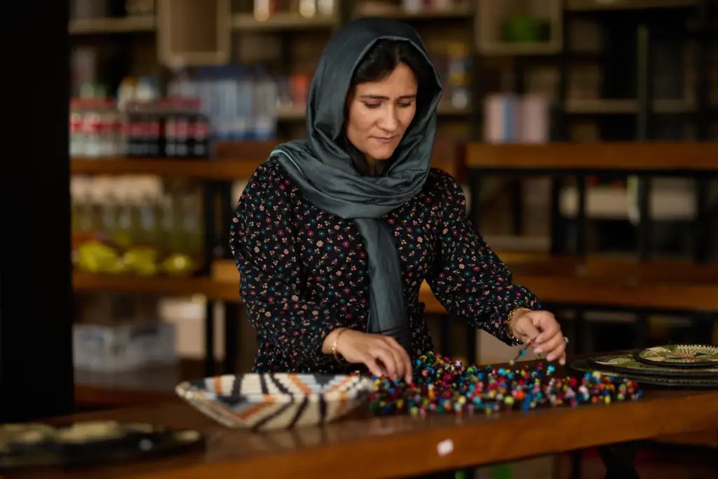 Shabana Basij-Rasikh arranges beads in Rwanda.