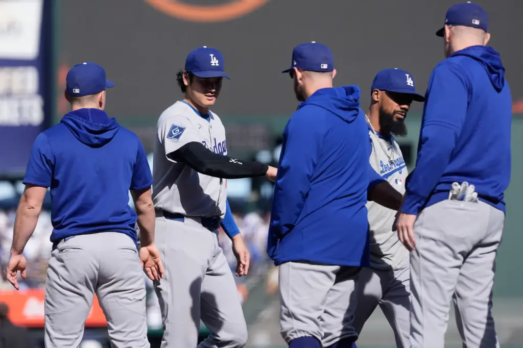 Dodgers’ Shohei Ohtani, second from left, and Teoscar HernÃ¡ndez, second...