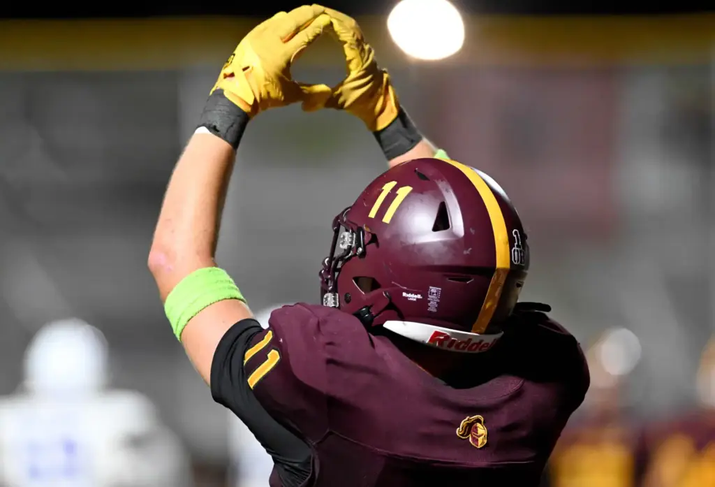 Valley Christian Defenders Sam Melcher (11) signals to his team...