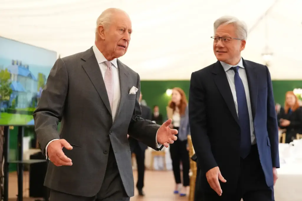 Britain's King Charles III walks with Nvidia chief executive Jensen Huang.