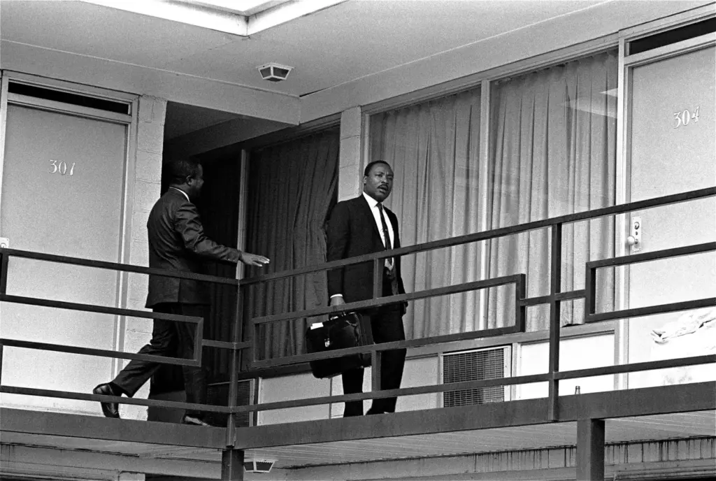 The Rev. Martin Luther King, Jr. walks across the balcony of the Lorraine Motel.