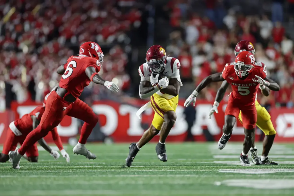 USC running back King Miller (8) rushes past Rutgers linebacker...