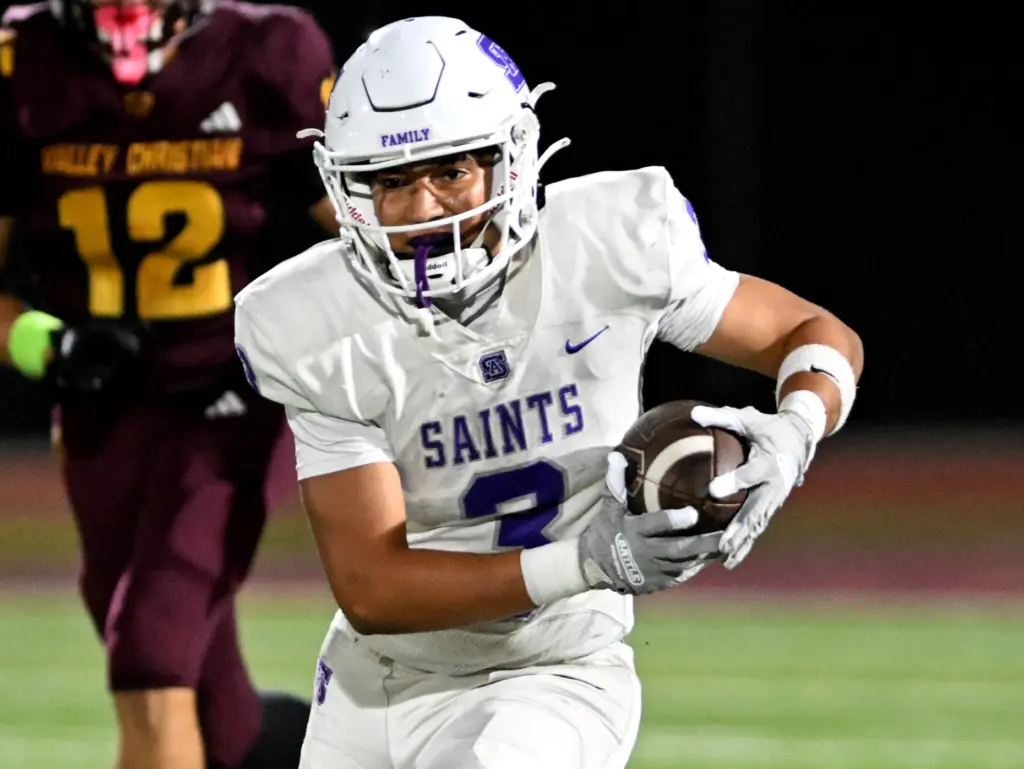 St. Anthony Saints Evan Martinez (3) runs for a first...