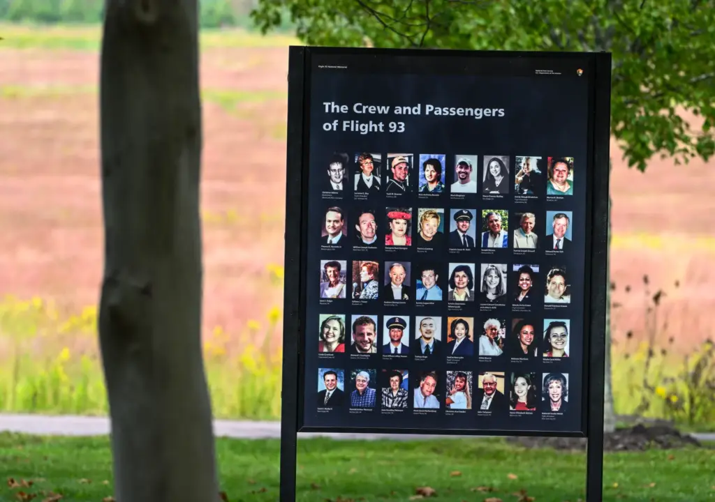 A board with pictures of the crew and passengers at...