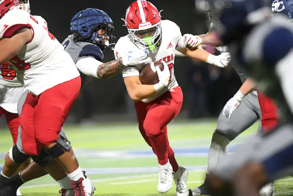 Orange Lutheranâs Ryan Christianson carries the ball against Sierra Canyon...
