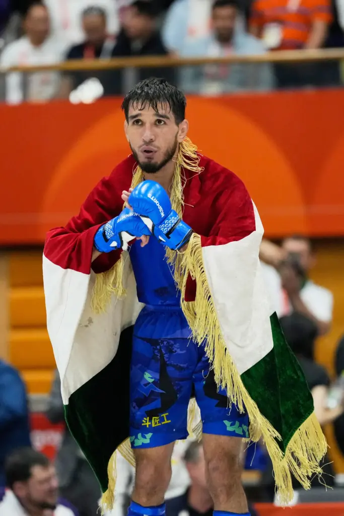 Mirzobek Umarov of Tajikistan reacts after winning the men's modern 60kg mixed martial arts final.