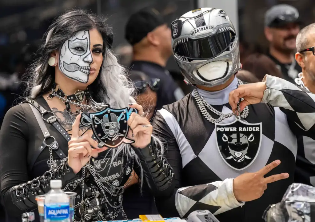 Raiders fans, including âPower Raider,â right, take their seats before...