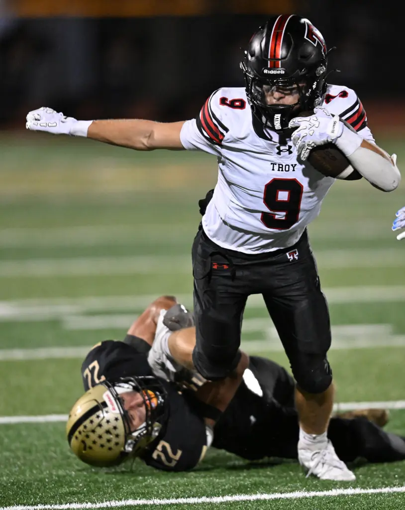 Chandler Lieberman #9 of Troy is tackled by Darius Selway...