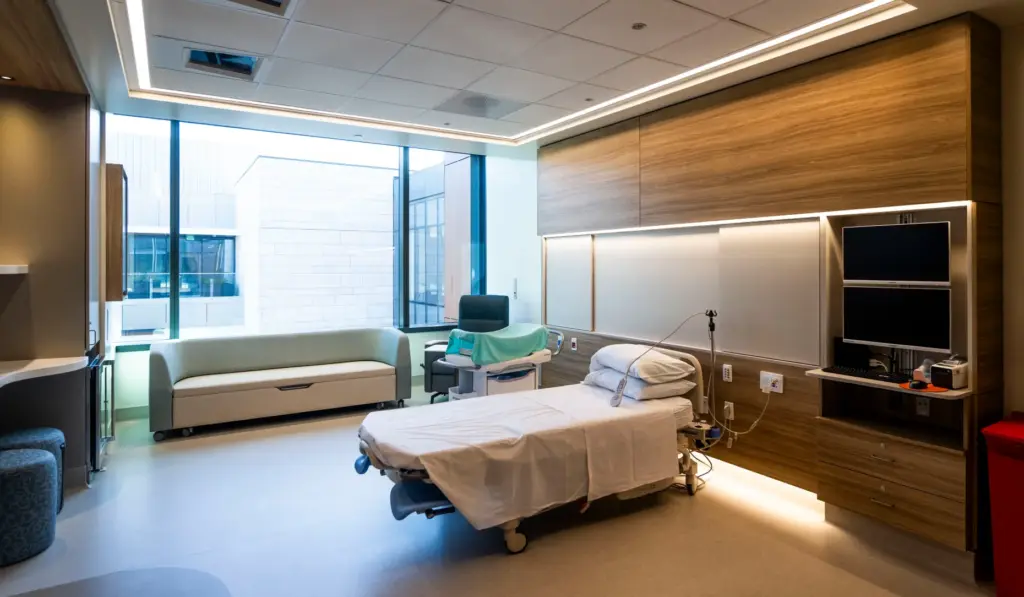 A birthing suite with a deep tub with a privacy...