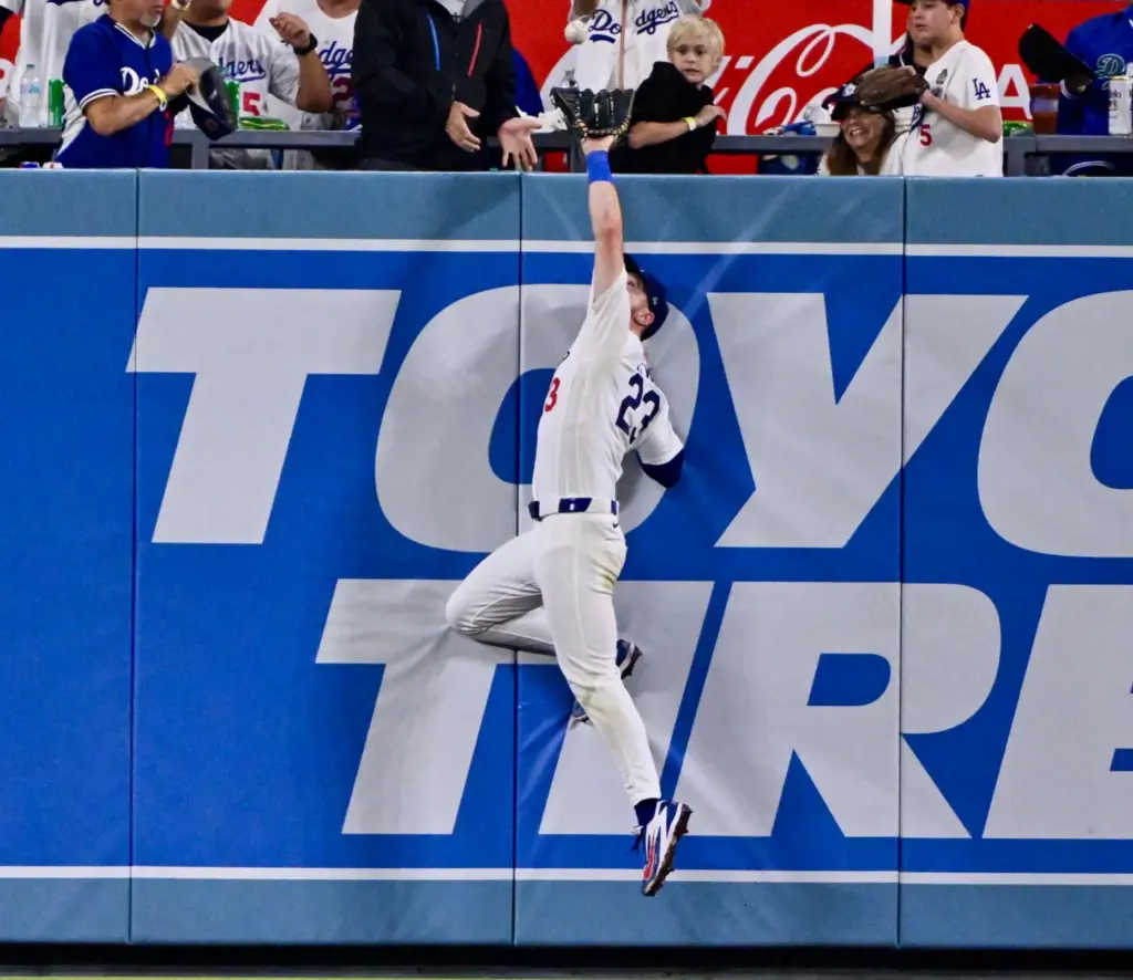 Dodgers right fielder Kyle Tucker makes a catch over the...
