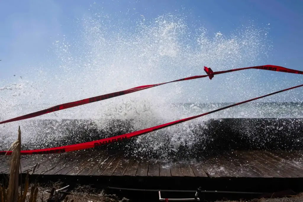 A large swell generated by Hurricane Polo surges into the...