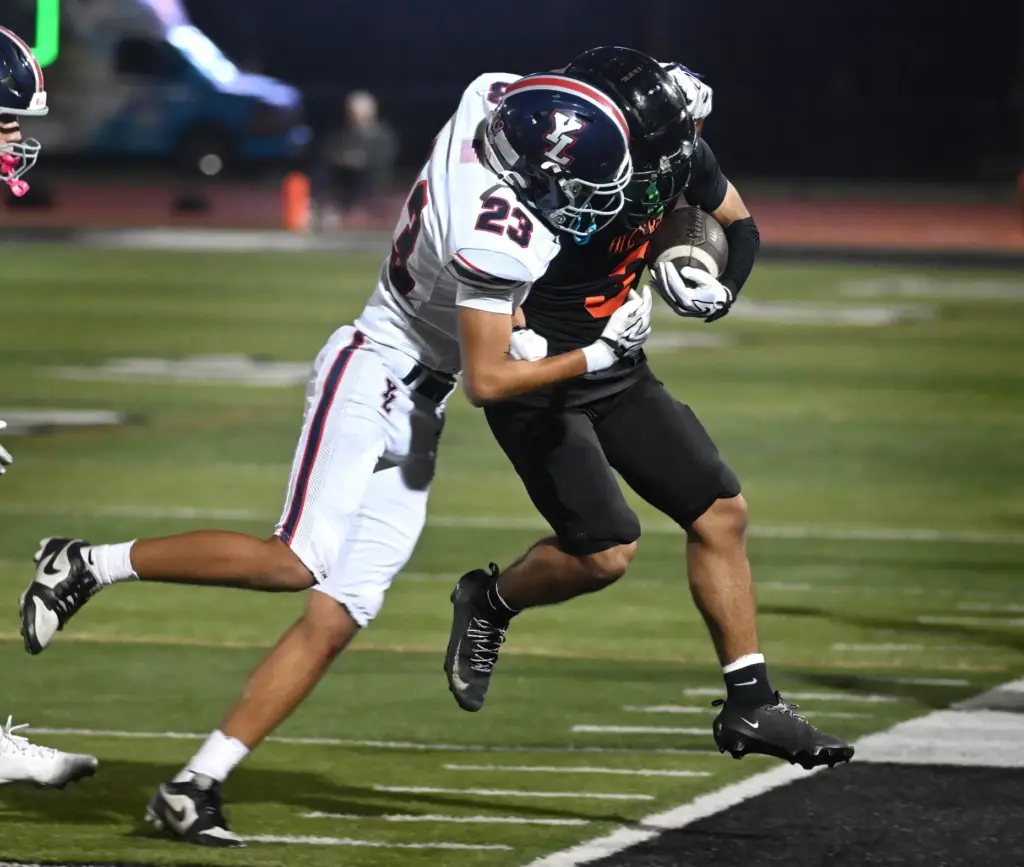 Yorba Lindaâs Aaron Burrell (23) pushes Nicolas Navarette (3) of...