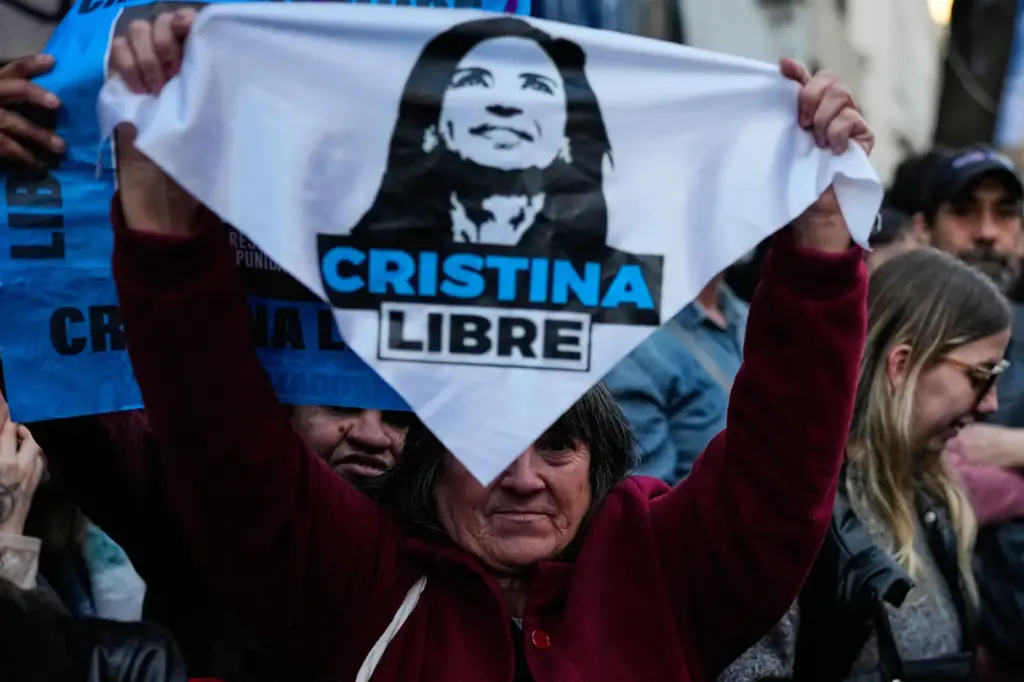 A supporter of former Argentine President Cristina Fernandez holds a sign reading 