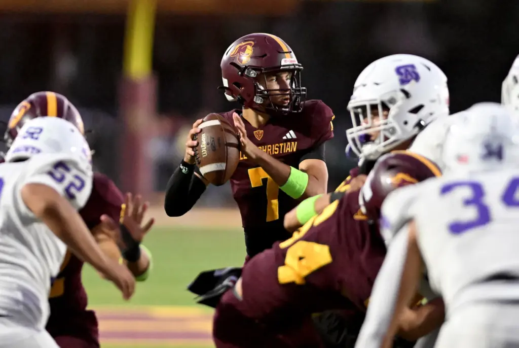 Valley Christian Defenders quarterback Graham Lunzer (7) looks to pass...