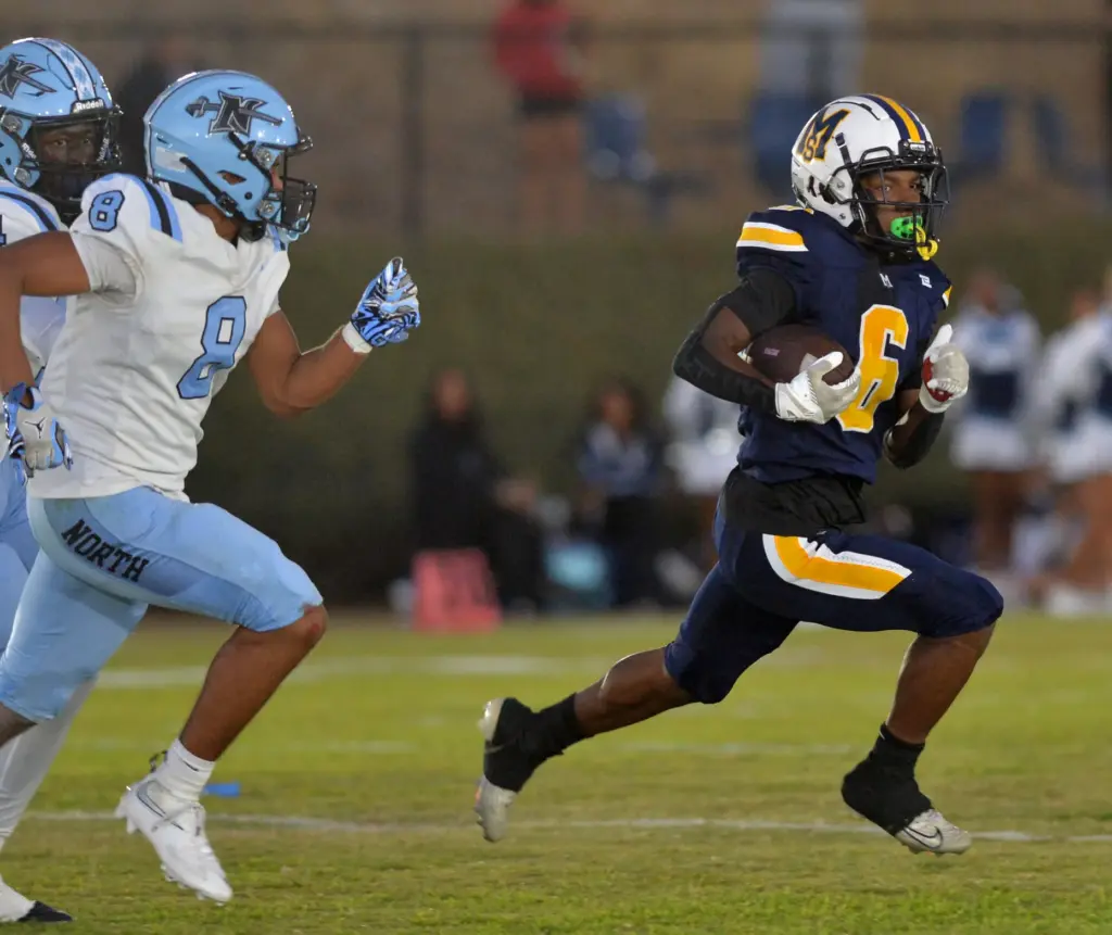 Mary Star back Myles Miller escapes North Torrance defenders in...