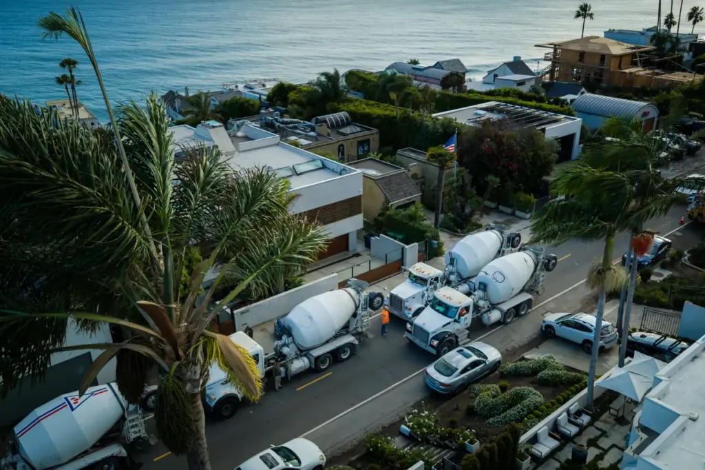 An aerial view construction vehicles lined up near a sinkhole...