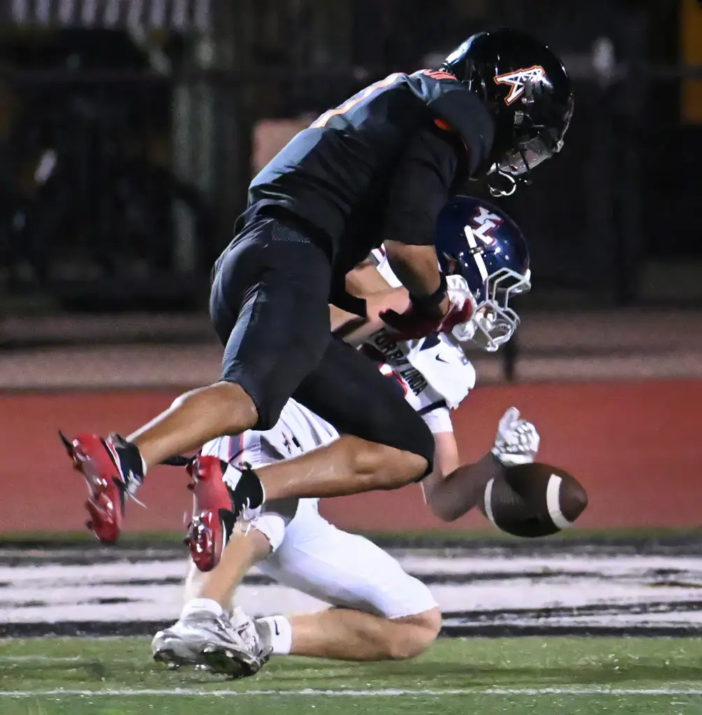 Connor Mackay (10) of Yorba Linda tries to hold onto...