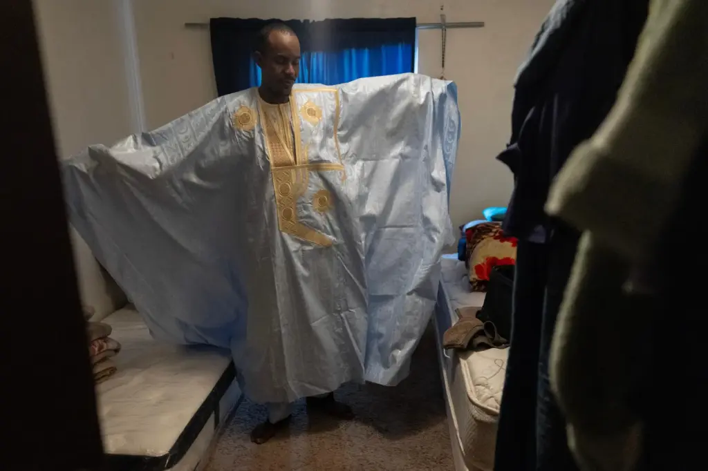 Samba Diallo displays his daraa, a loose-fitting traditional robe worn...