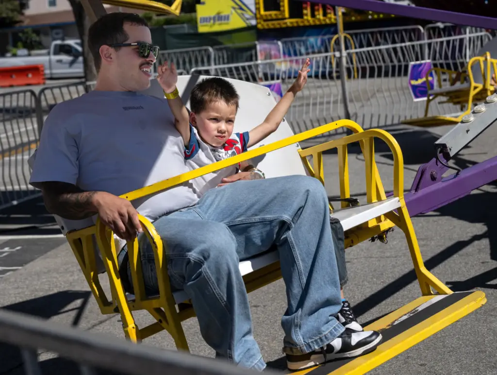 Andres Leyva rides the Windjammer with his 4-year-old son Kayden...