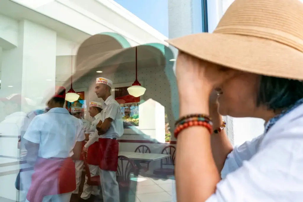 Angela Leu looks through the window of In-N-Out Burger with...