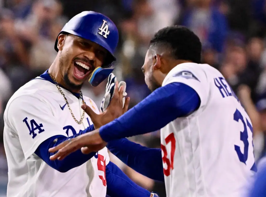 Dodgers shortstop Mookie Betts celebrates with teammate Teoscar HernÃ¡ndez after...