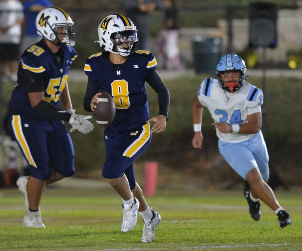 Mary Star QB Ian Ditch looks to throw against North...
