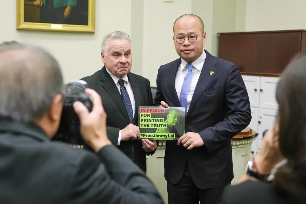 Sebastien Lai speaks, right and Rep. Chris Smith, R-N.J., left,...