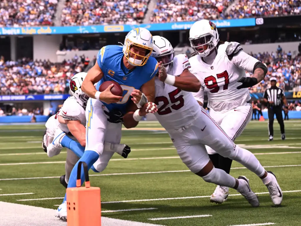 Chargers quarterback Justin Herbert (10) scrambles for yardage against Arizona...