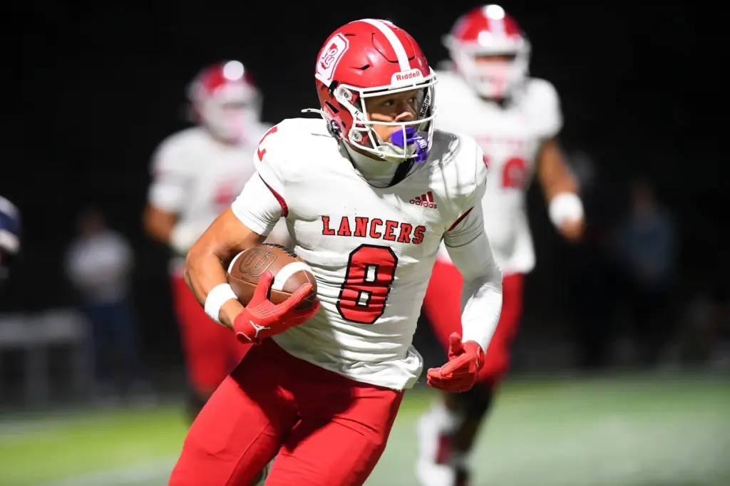 Orange Lutheranâs Nico Bland gains yards against Sierra Canyon during...