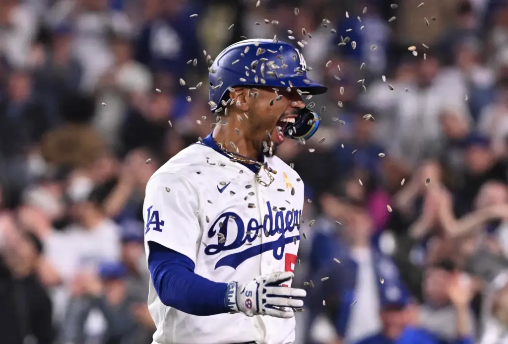 Dodgers shortstop Mookie Betts is showered with sunflower seeds by...