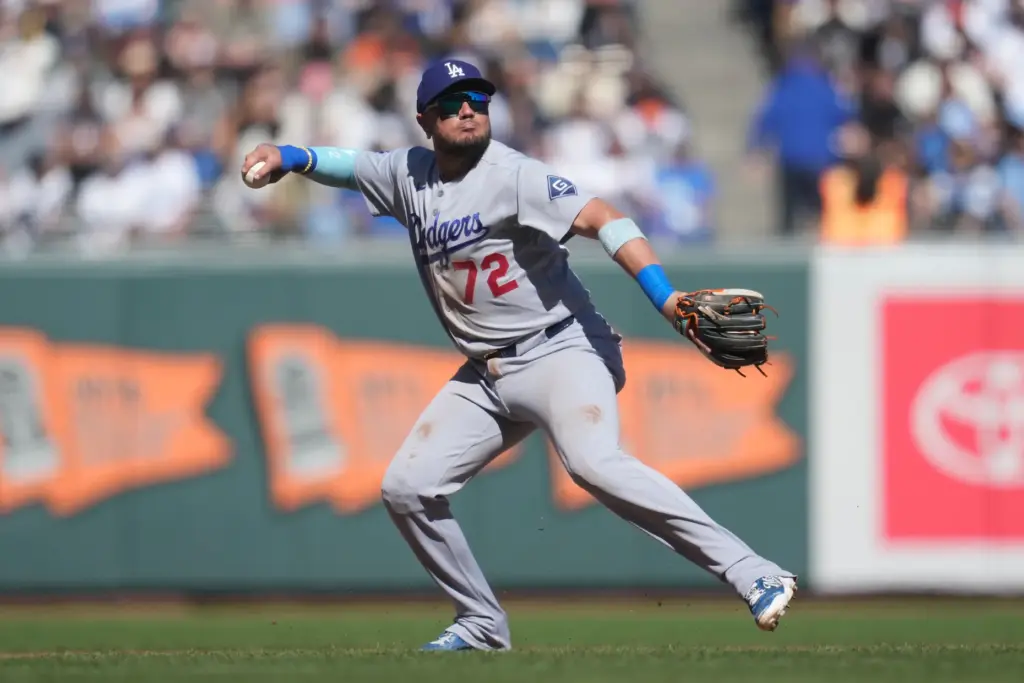 Dodgers third baseman Miguel Rojas (72) throws out San Francisco...