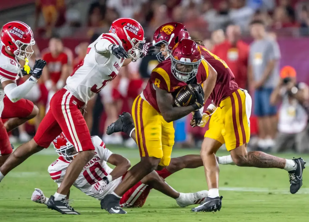 USC running back King Miller (8) breaks a tackle while...